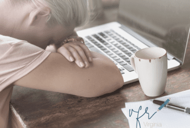 blonde female with head on keyboard writers block